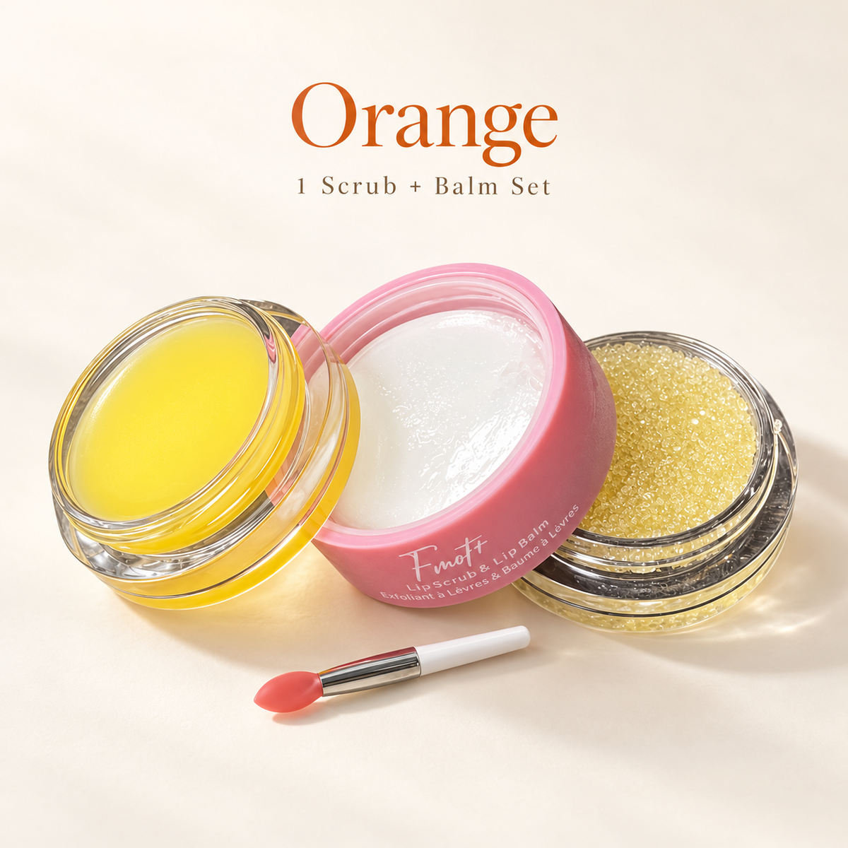 orange single lip scrub and balm set, with clear round packaging and pink label.