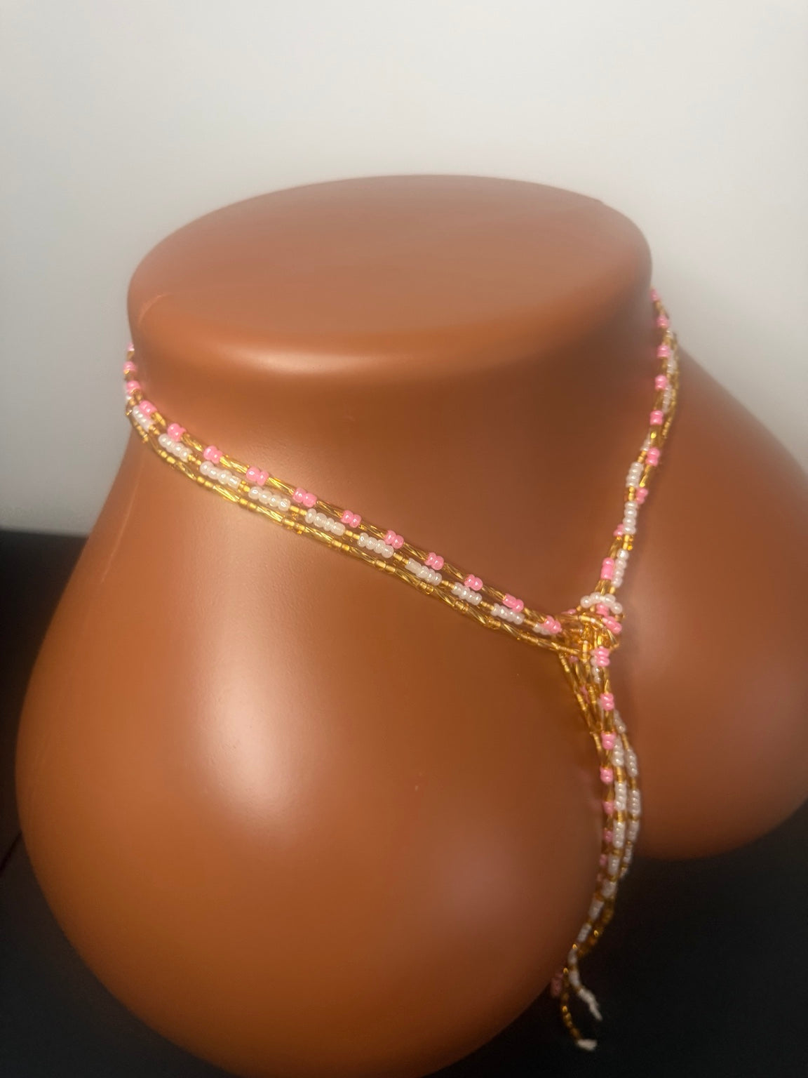 Blush Luxe: 3 separate tie-on waist bead strands; Pink & Gold, Pearl & Gold, Classic Gold. Actual product photo on display mannequin.