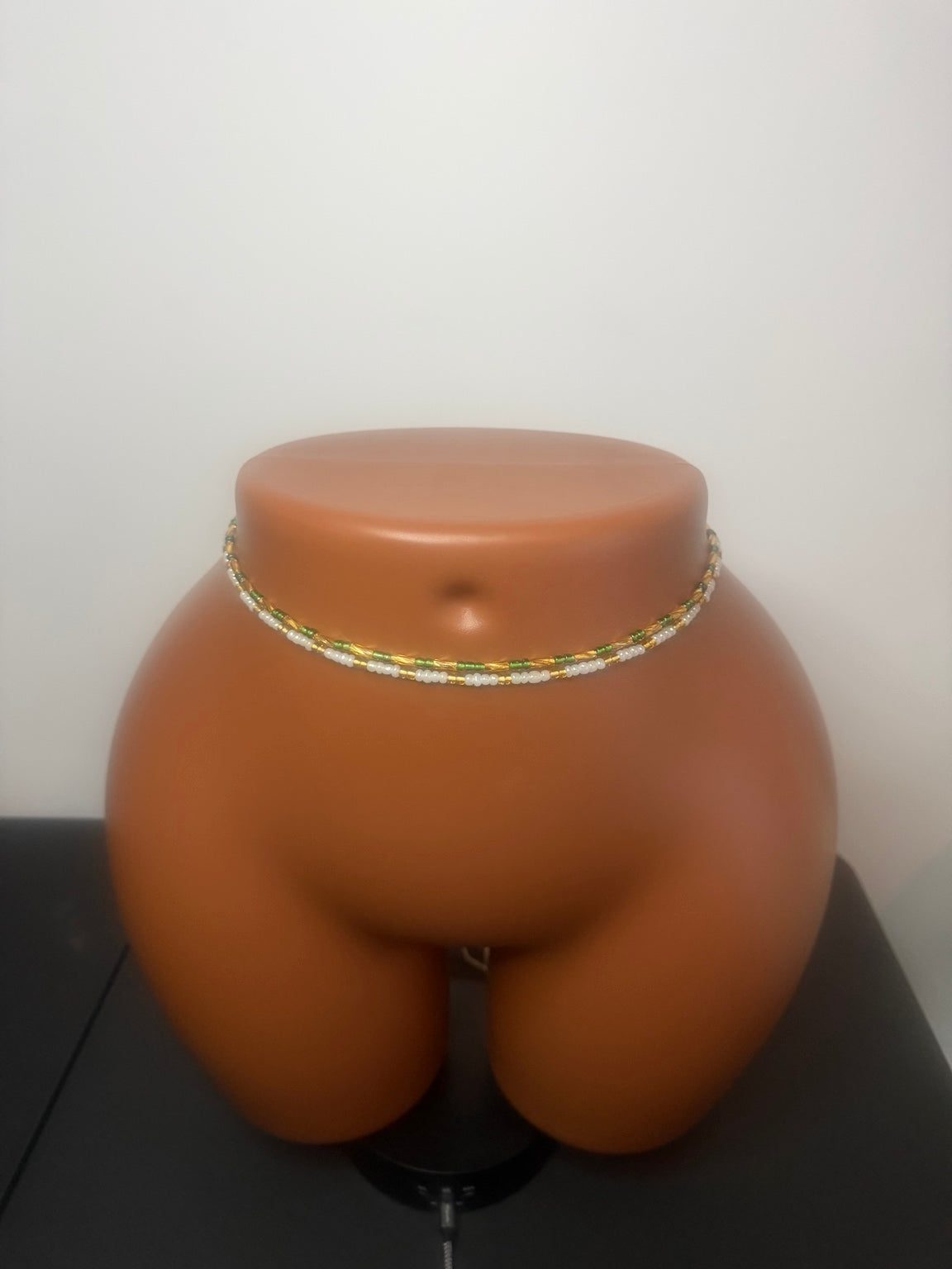 Emerald Duo: 2 separate tie-on waist bead strands; Emerald Green & Gold, Pearl & Gold. Actual product photo on display mannequin.