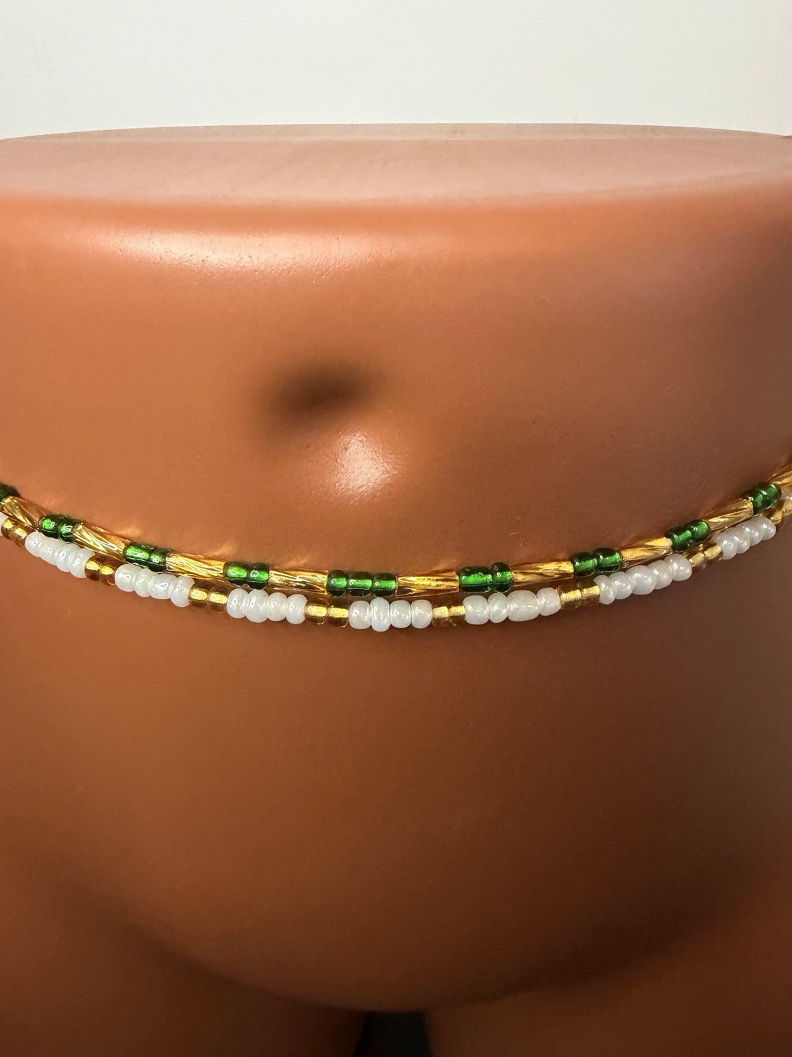 Emerald Duo: 2 separate tie-on waist bead strands; Emerald Green & Gold, Pearl & Gold. Actual product photo on display mannequin.