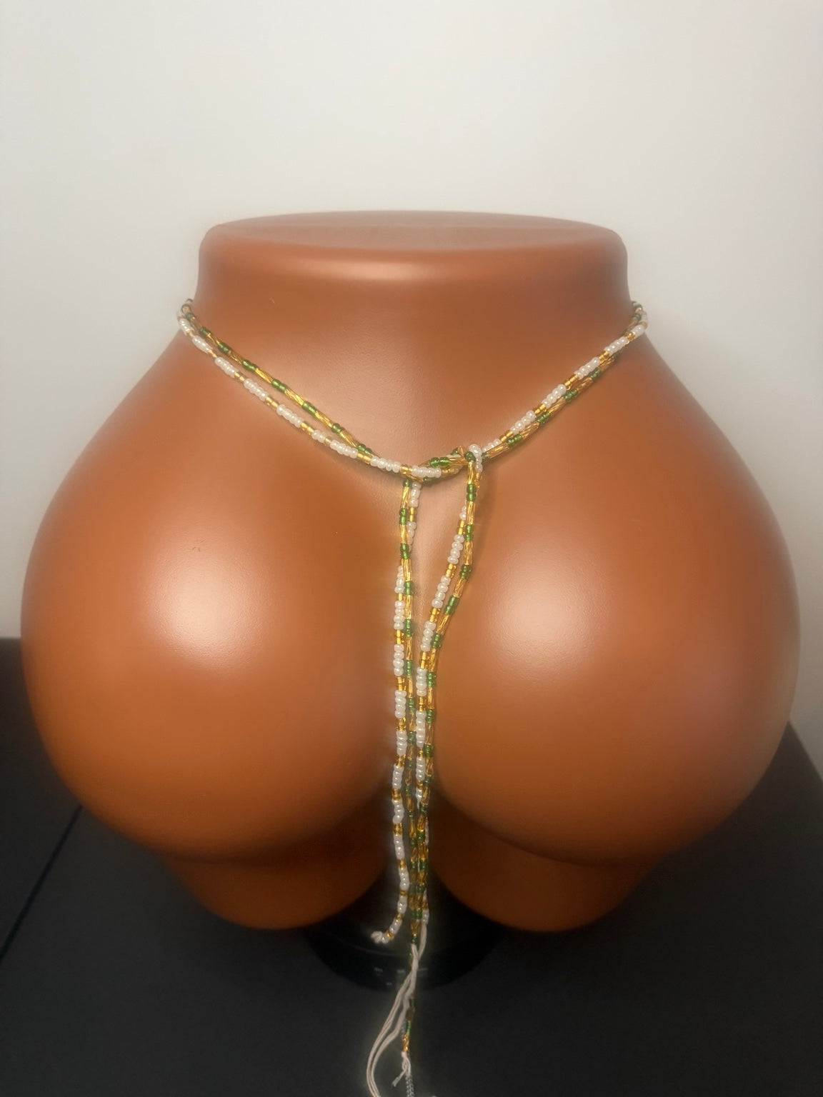 Emerald Duo: 2 separate tie-on waist bead strands; Emerald Green & Gold, Pearl & Gold. Actual product photo on display mannequin.