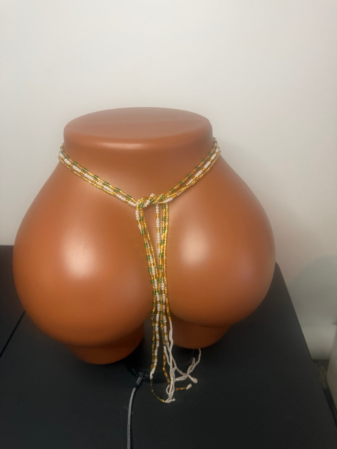 Emerald Luxe: 3 separate tie-on waist bead strands; Emerald Green & Gold, Pearl & Gold, Classic Gold. Actual product photo on display mannequin.